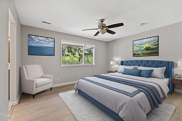 a bedroom with bed and a chandelier