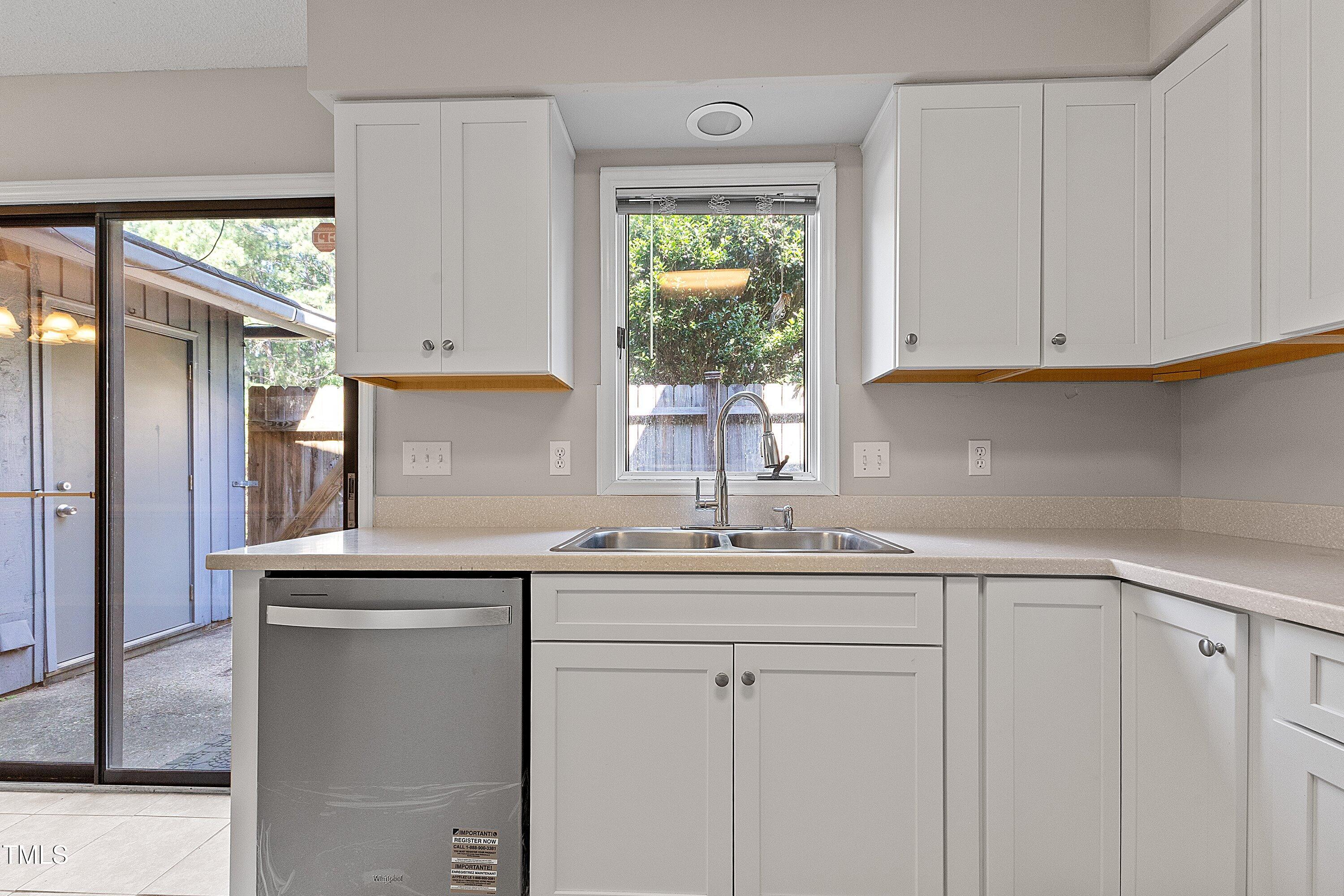 4350 Hunters Club Drive Raleigh, NC 27606 - Photo 5 of 33 a kitchen with stainless steel appliances granite countertop a sink and a window