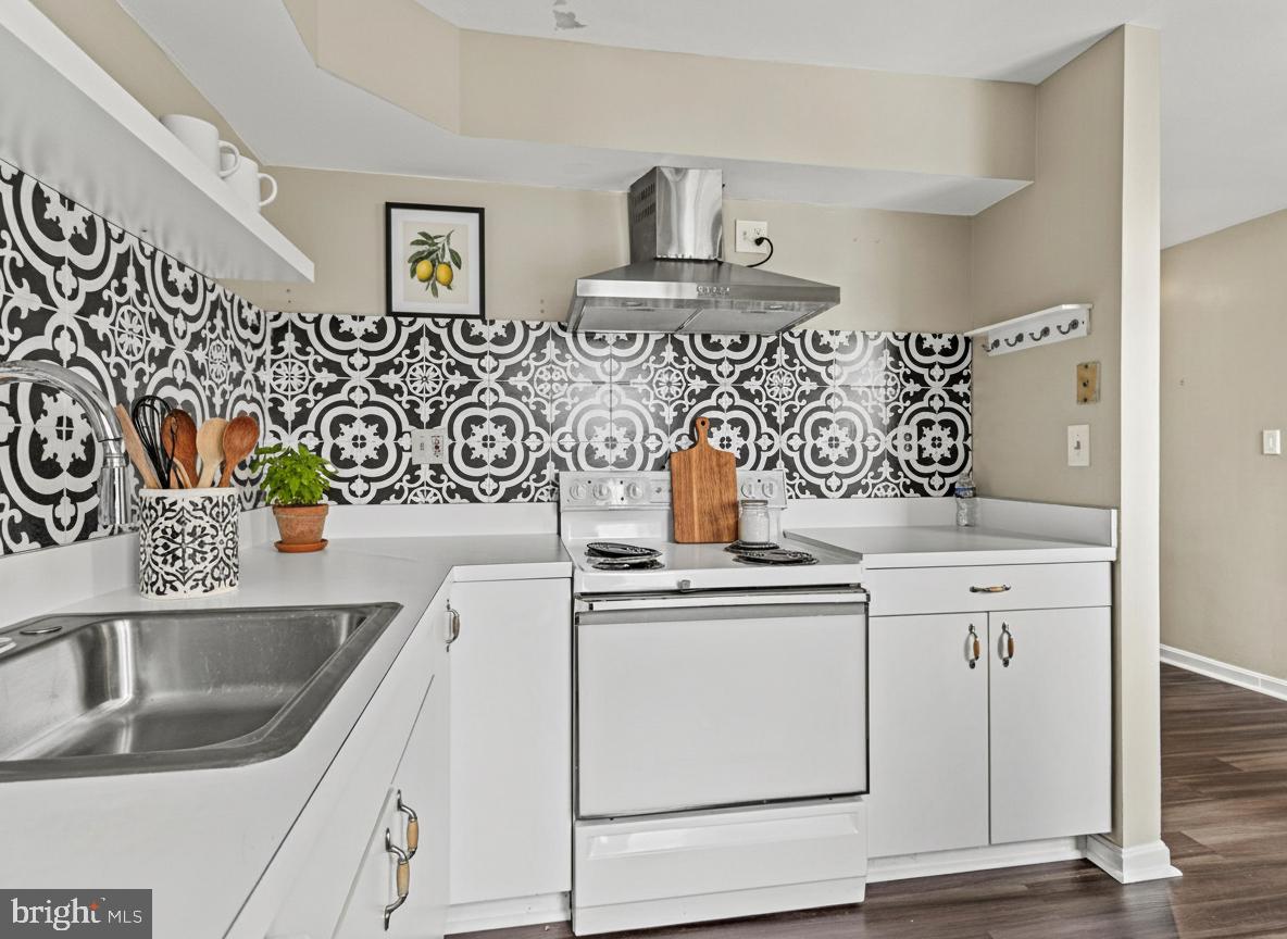 911 South Charles Street, Unit 409 Baltimore, MD 21230 - Photo 12 of 16 a kitchen with stainless steel appliances granite countertop a sink and a stove