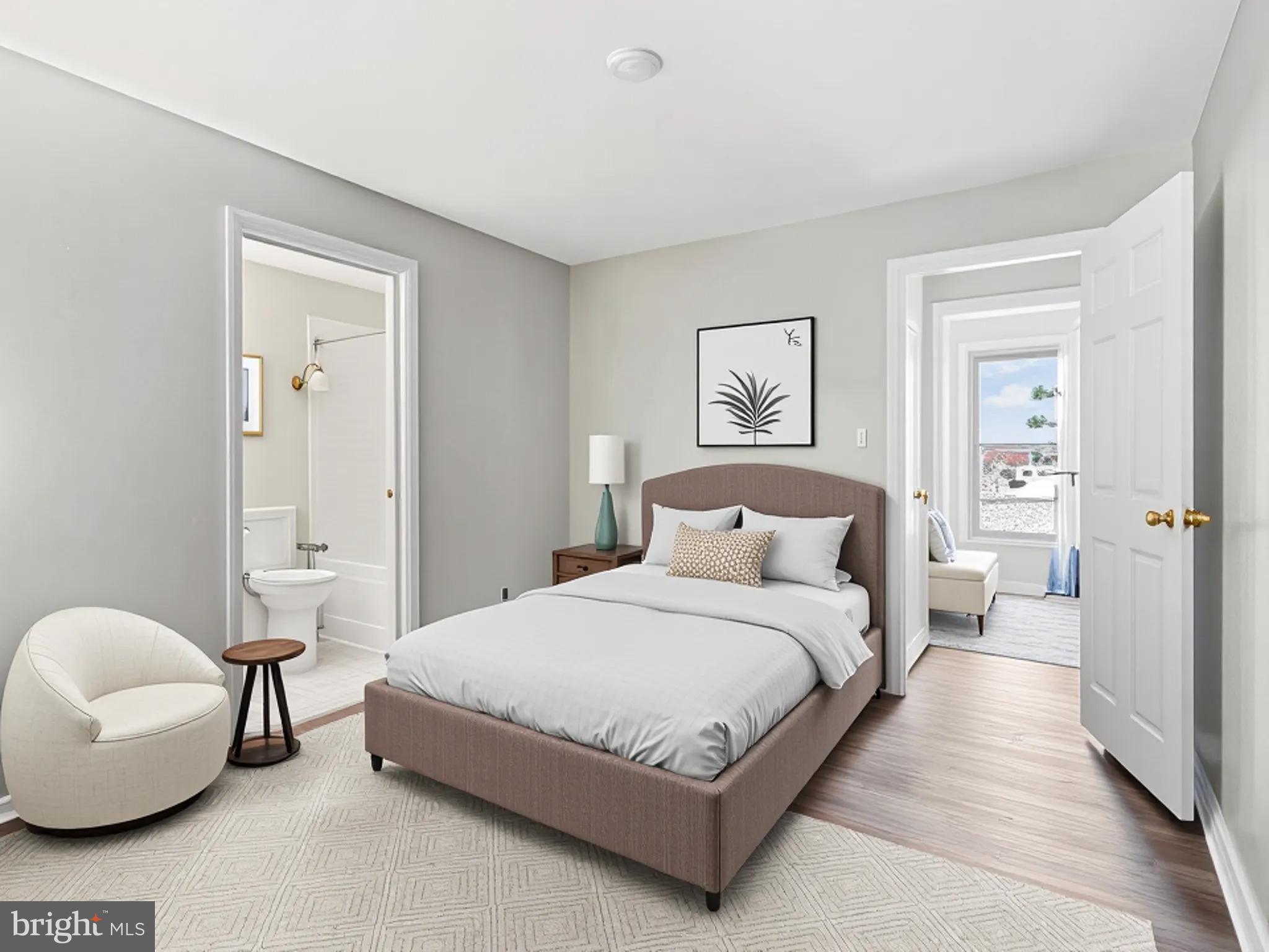 911 South Charles Street, Unit 409 Baltimore, MD 21230 - Photo 6 of 16 a spacious bedroom with a bed and a couch