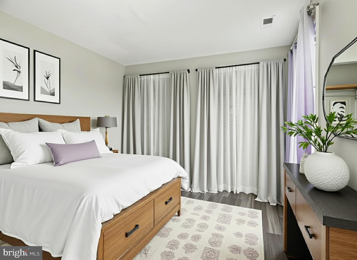 911 South Charles Street, Unit 409 Baltimore, MD 21230 - Photo 9 of 16 a bedroom with a bed and a window