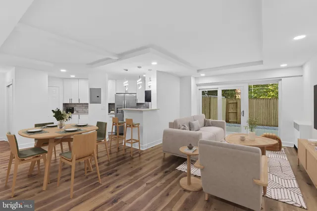 a living room with furniture and a dining table with kitchen view