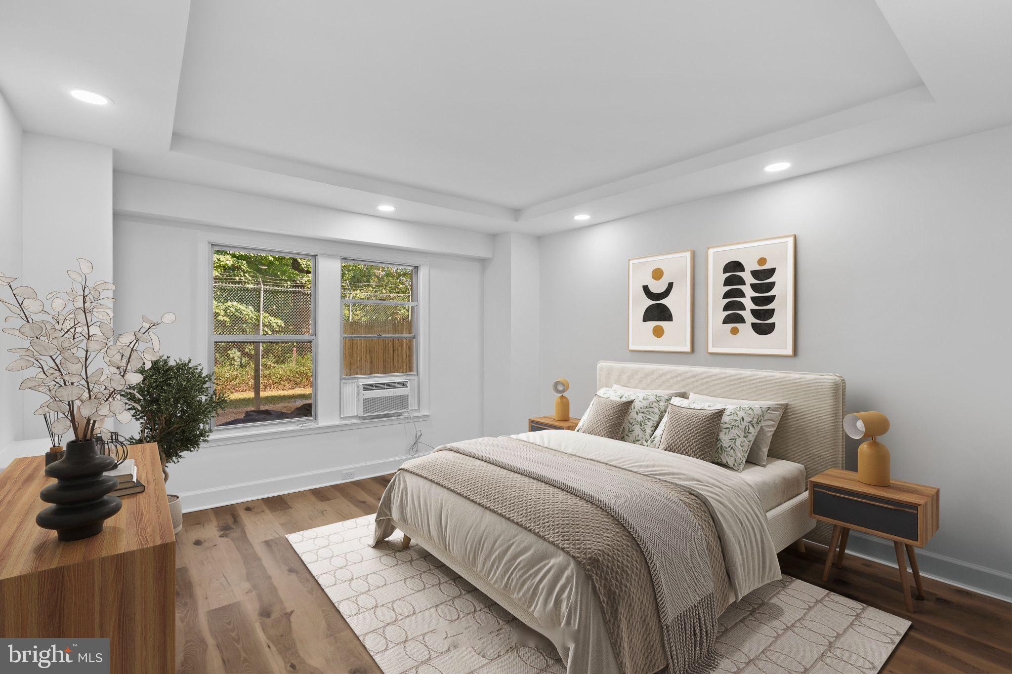 2500 Q Street Northwest, Unit 106 Washington, DC 20007 - Photo 14 of 21 a bedroom with a large bed and a large window