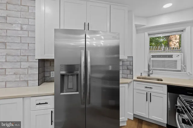 a kitchen with a sink and refrigerator