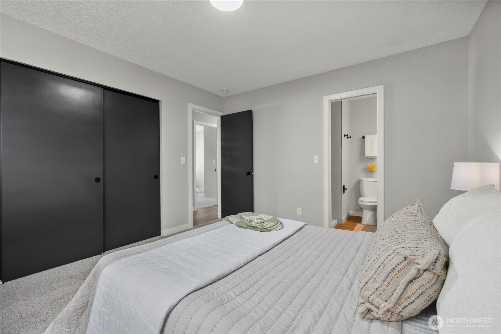 16531 120th Avenue Southeast Renton, WA 98058 - Photo 12 of 25 a bedroom with a bed and wooden floor