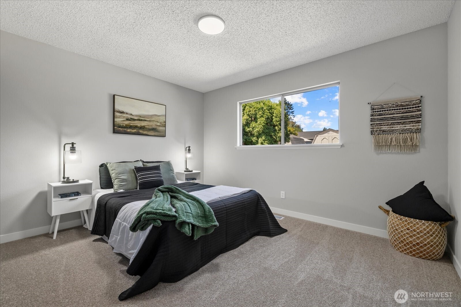 16531 120th Avenue Southeast Renton, WA 98058 - Photo 15 of 25 a bed room with a bed and a painting on the wall
