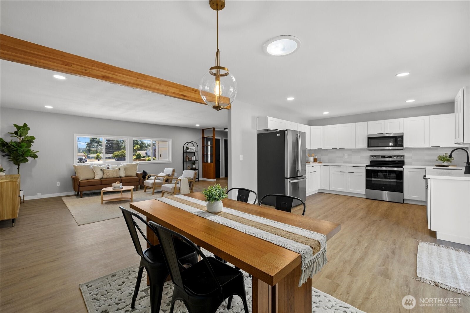 16531 120th Avenue Southeast Renton, WA 98058 - Photo 5 of 25 a kitchen with sink a refrigerator and chairs