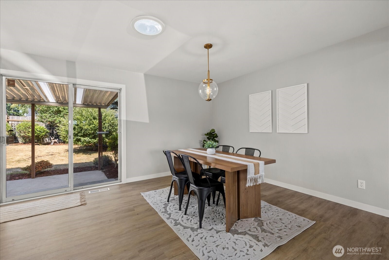 16531 120th Avenue Southeast Renton, WA 98058 - Photo 7 of 25 a view of a dining room with furniture window and wooden floor
