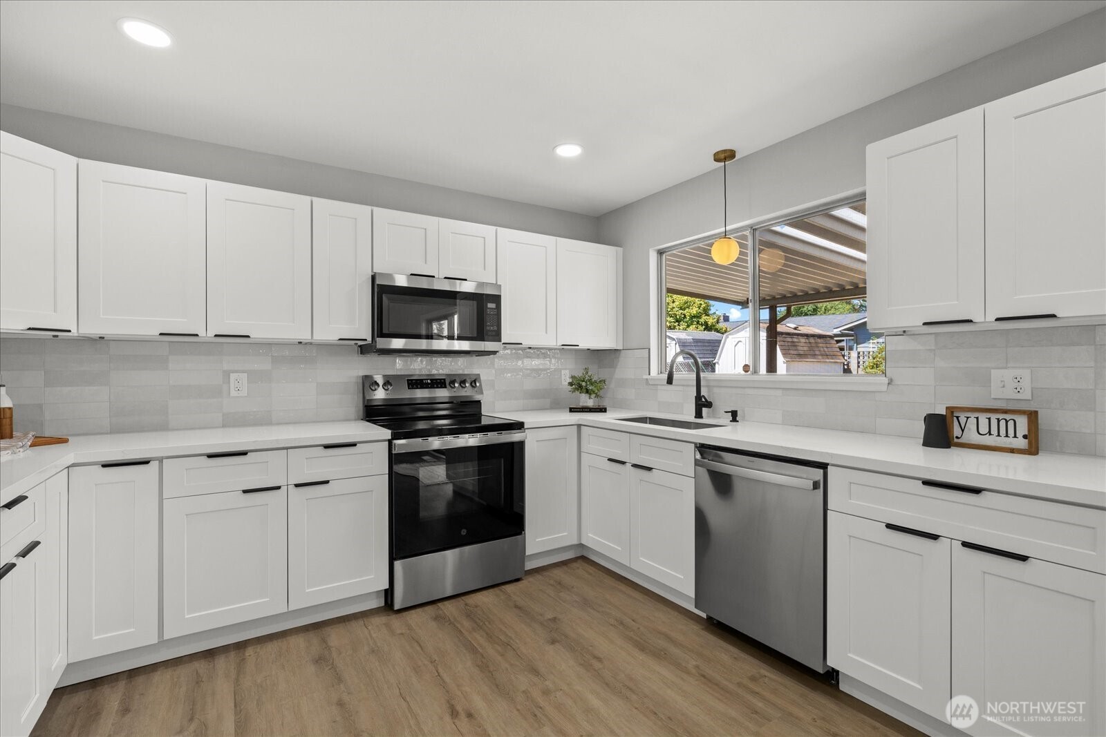 16531 120th Avenue Southeast Renton, WA 98058 - Photo 10 of 25 a kitchen with granite countertop white cabinets and stainless steel appliances