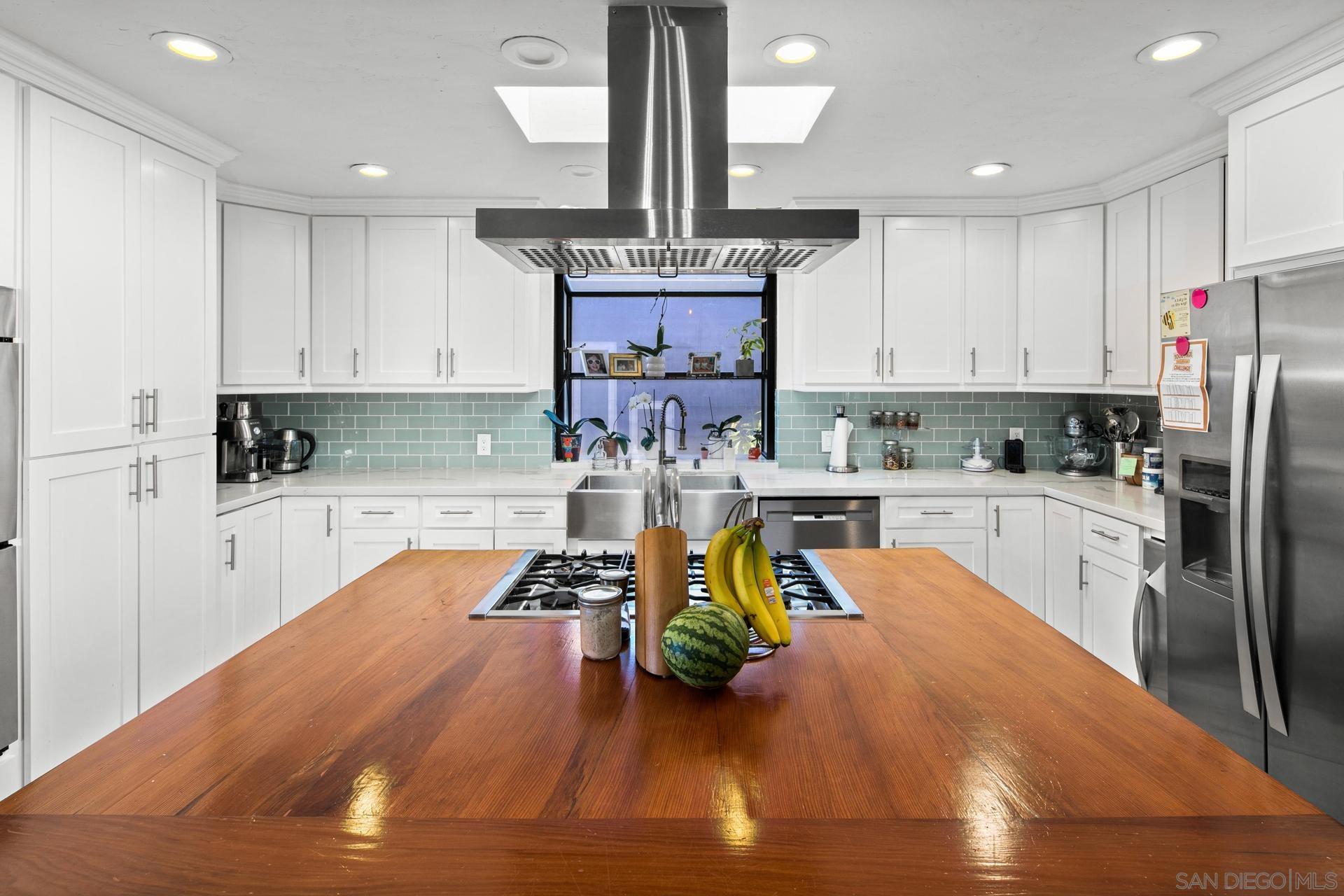 a kitchen with wooden floors sink and cabinets