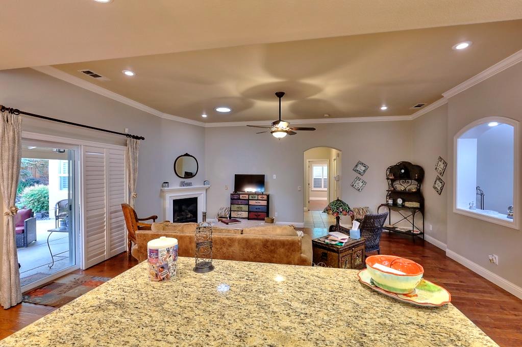 4152 Post Oak Drive Turlock, CA 95382 - Photo 36 of 71 a living room with furniture a fireplace and a chandelier