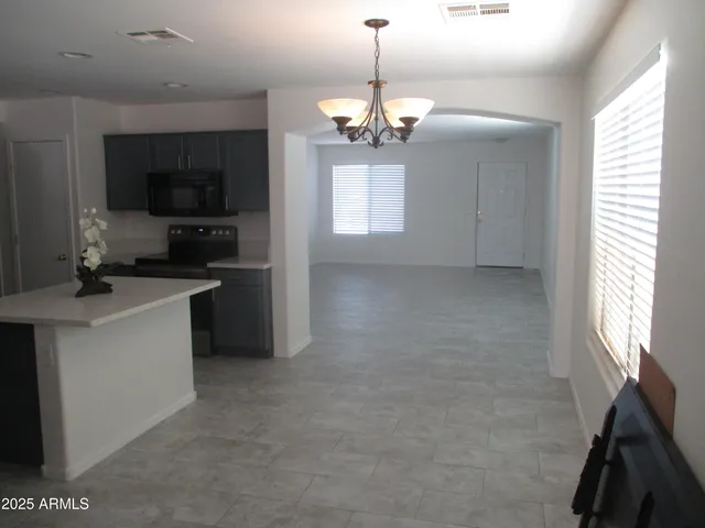 a kitchen that has a sink and a stove top oven