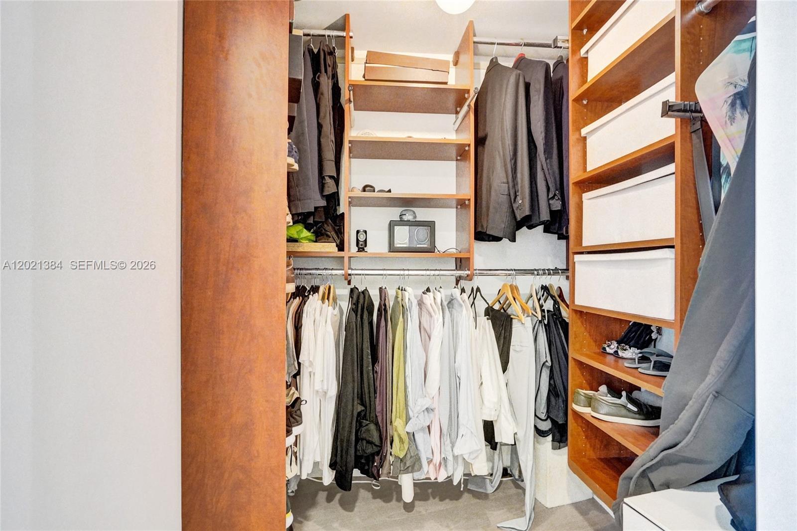 400 Alton Road, Unit PH11 Miami Beach, FL 33139 - Photo 34 of 49 a view of walk in closet with clothes and shoes