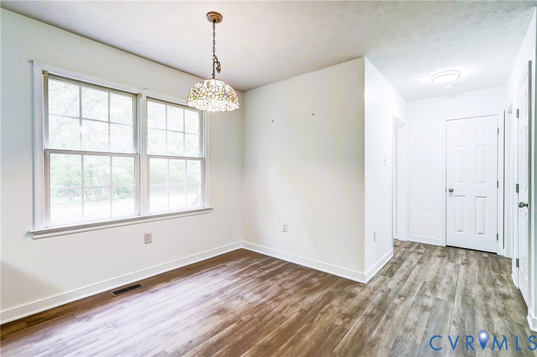 3820 Mt Pleasant Road Providence Forge, VA 23140 - Photo 8 of 40 wooden floor in an empty room with a window