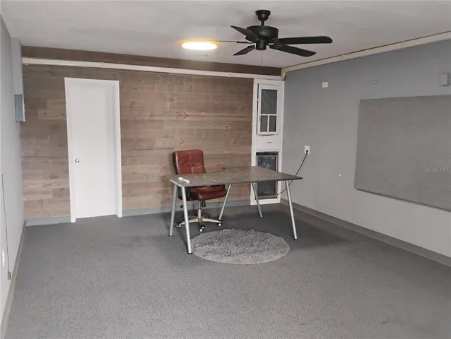 a workspace with furniture and a potted plant