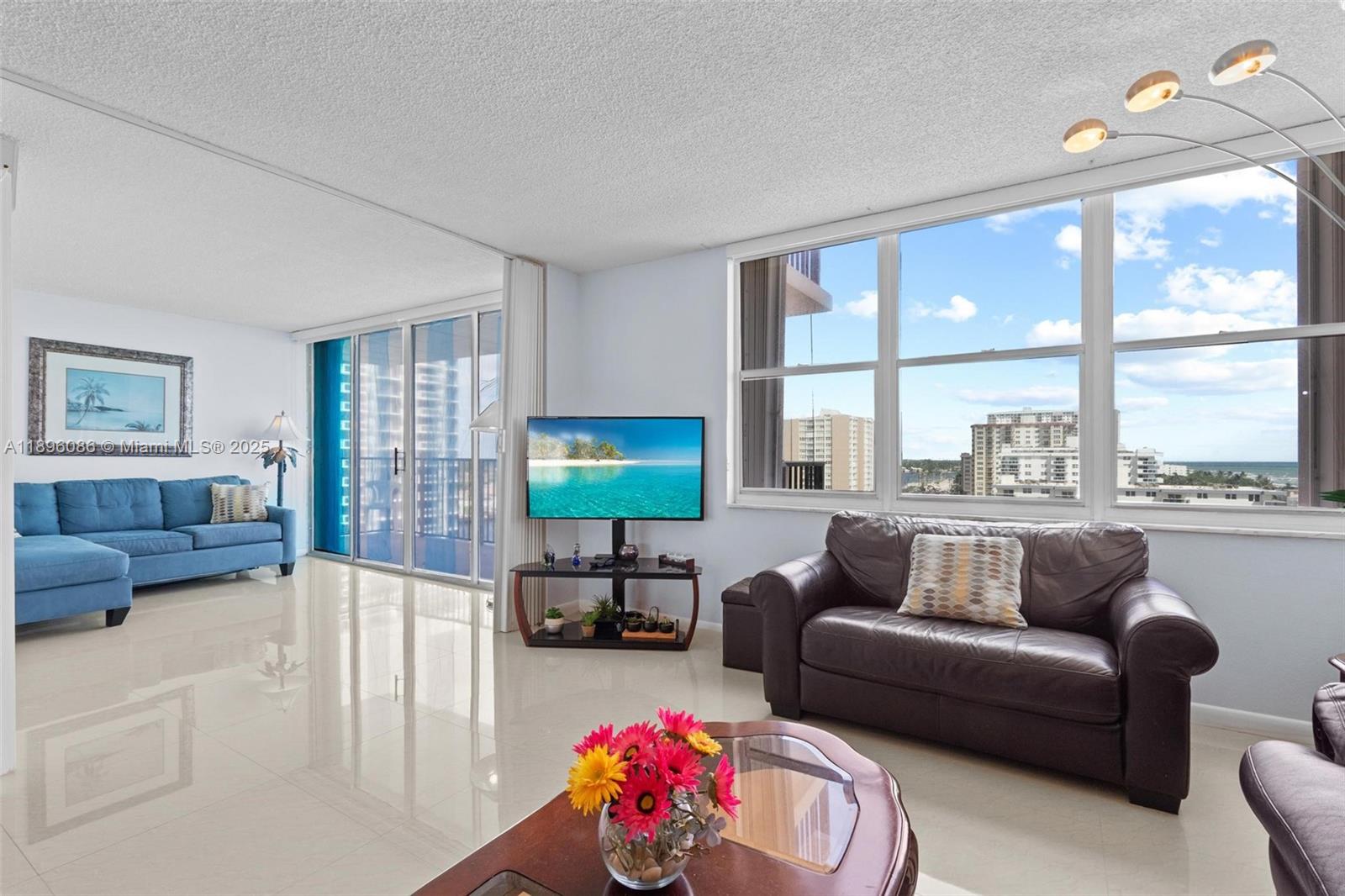 2101 South Ocean Drive, Unit 905 Hollywood, FL 33019 - Photo 12 of 38 a living room with furniture and a large window