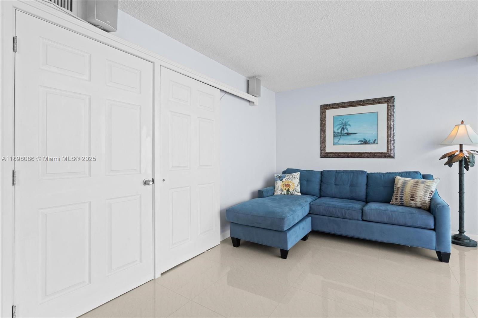 2101 South Ocean Drive, Unit 905 Hollywood, FL 33019 - Photo 15 of 38 a living room with furniture and a wall painting