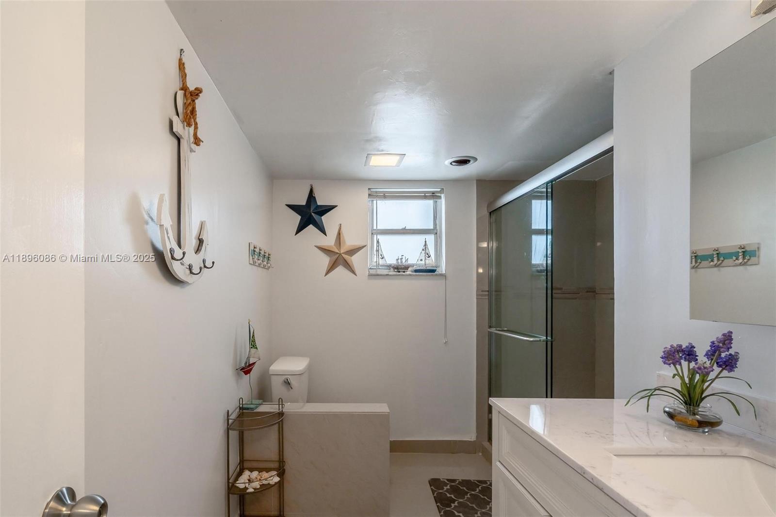 2101 South Ocean Drive, Unit 905 Hollywood, FL 33019 - Photo 18 of 38 a bathroom with a granite countertop sink a toilet and shower