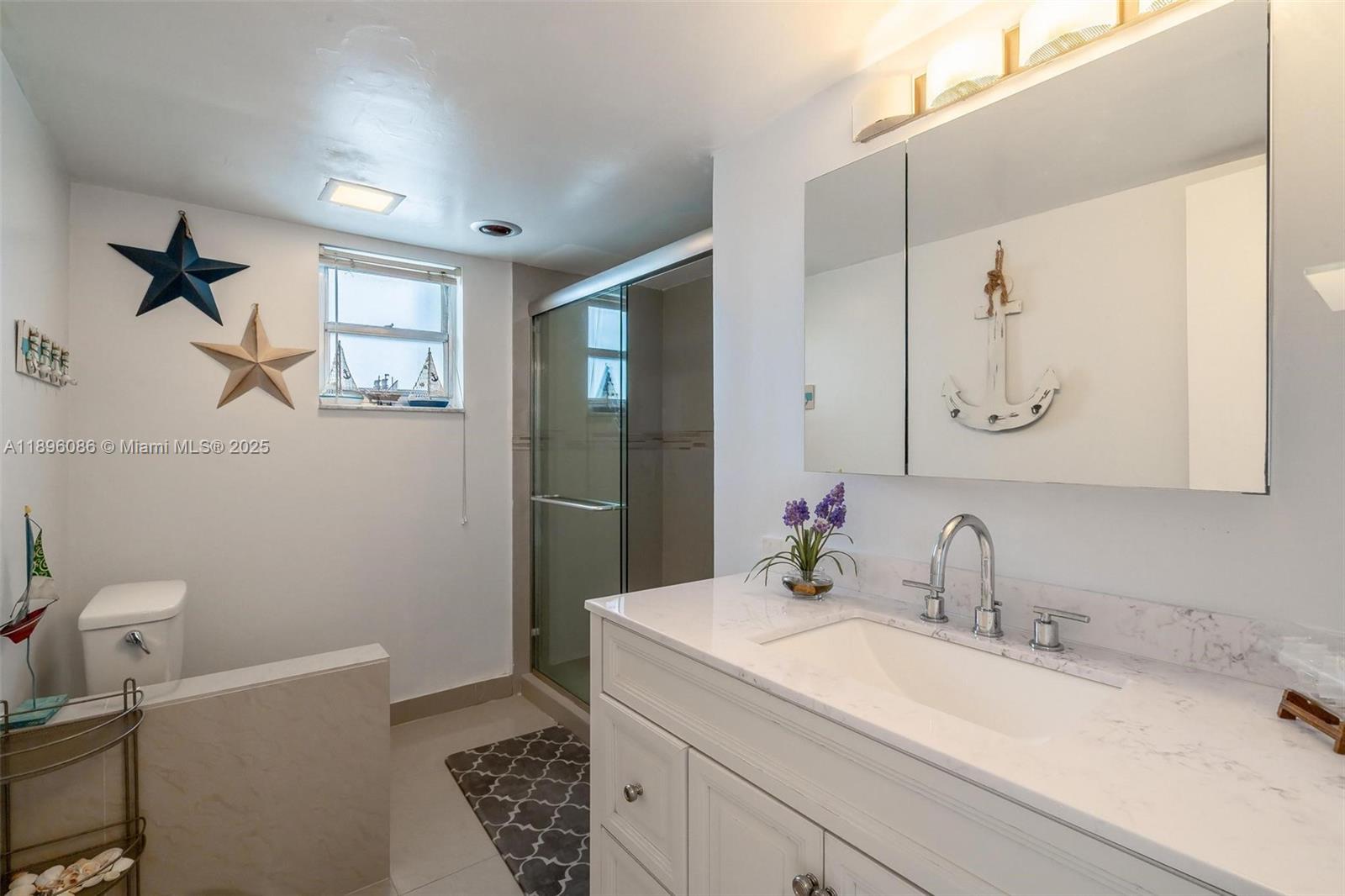 2101 South Ocean Drive, Unit 905 Hollywood, FL 33019 - Photo 19 of 38 a bathroom with a sink a toilet and shower