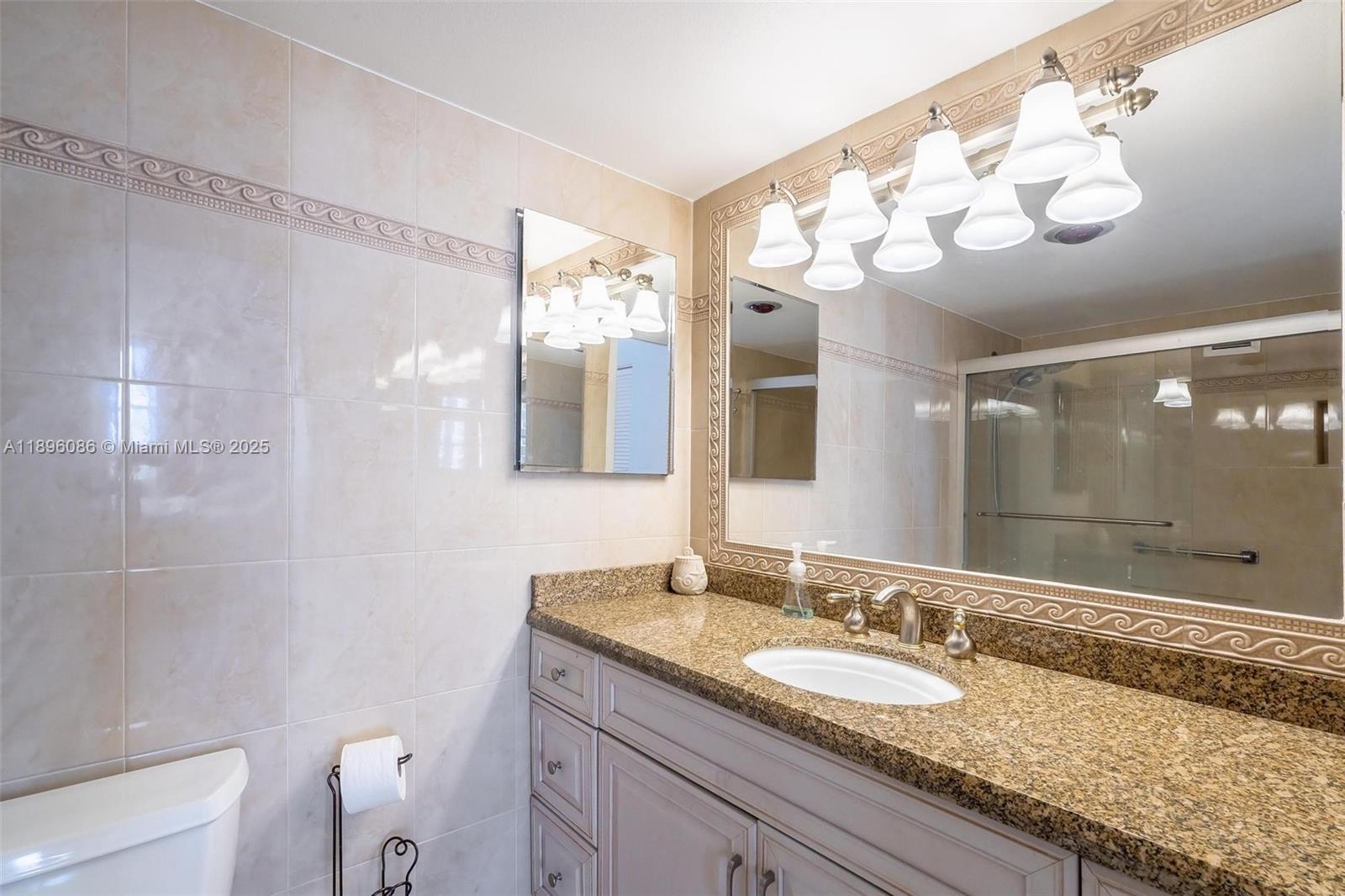 2101 South Ocean Drive, Unit 905 Hollywood, FL 33019 - Photo 24 of 38 a bathroom with a granite countertop sink mirror and shower