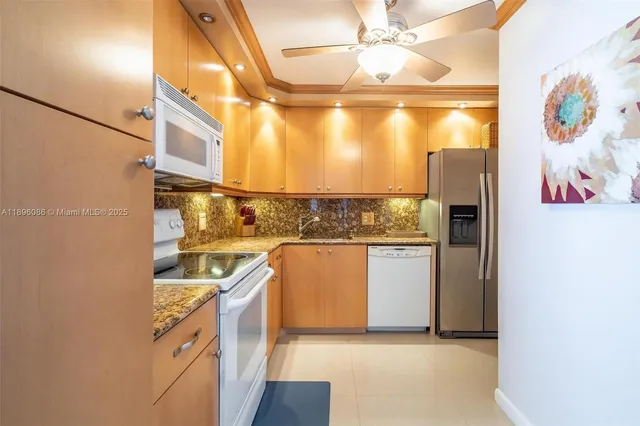 a kitchen with stainless steel appliances granite countertop a refrigerator and a stove