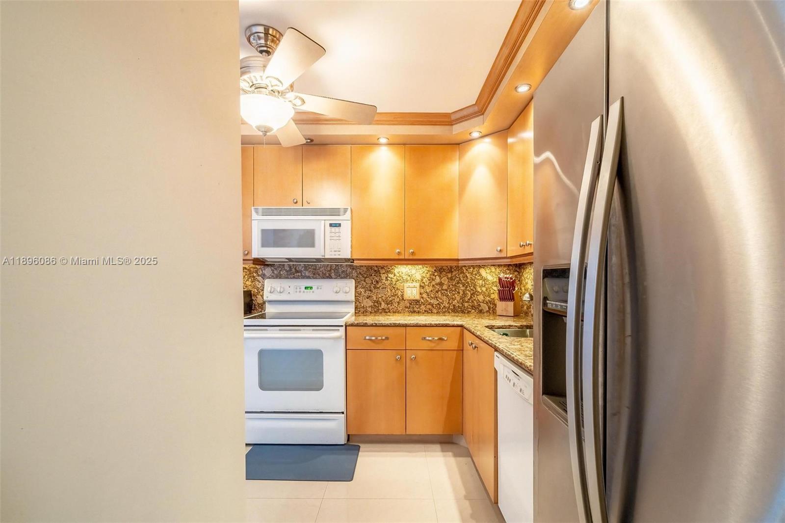 2101 South Ocean Drive, Unit 905 Hollywood, FL 33019 - Photo 4 of 38 a kitchen with a refrigerator and countertop