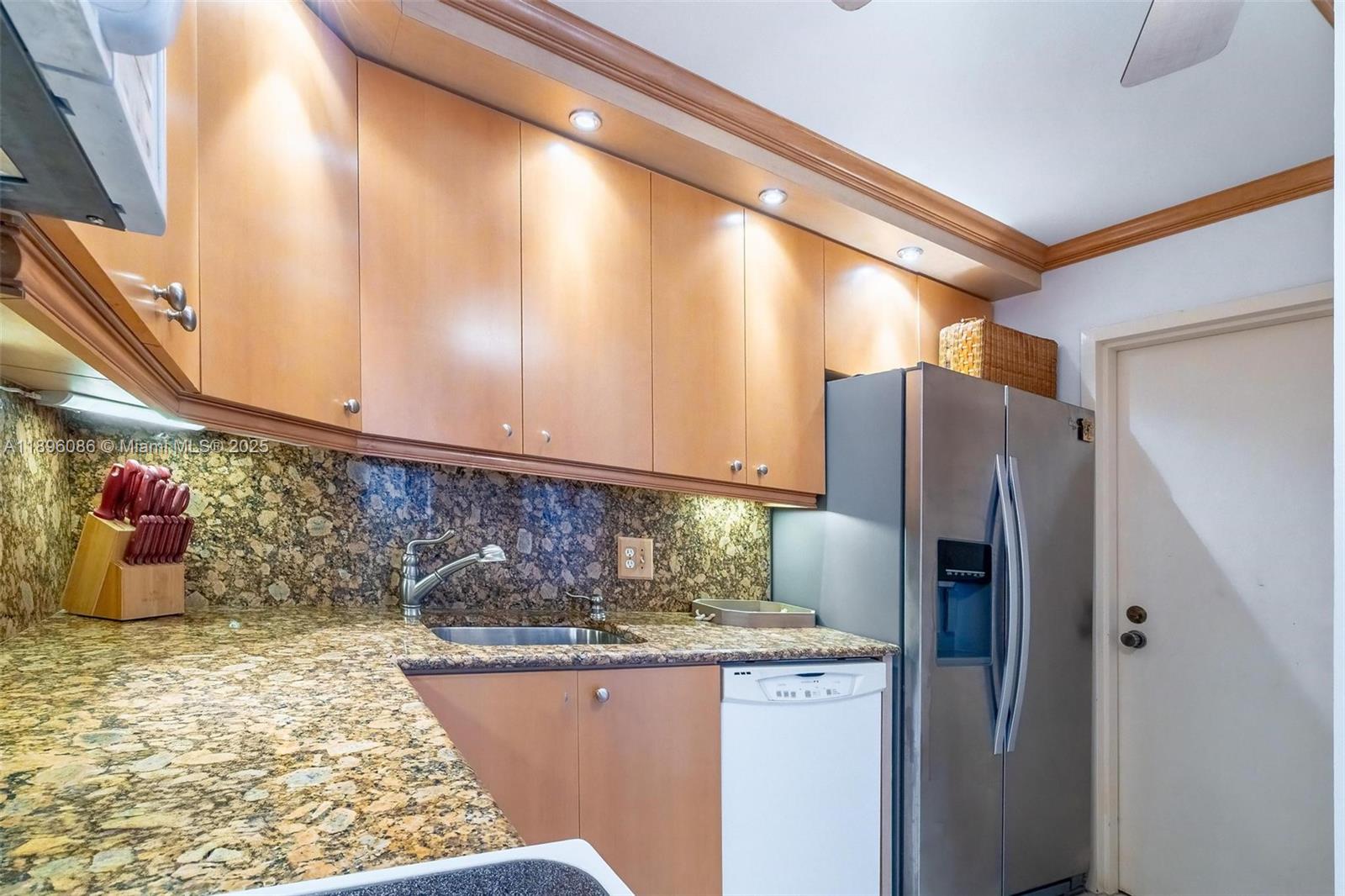 2101 South Ocean Drive, Unit 905 Hollywood, FL 33019 - Photo 6 of 38 a kitchen with refrigerator and mirror