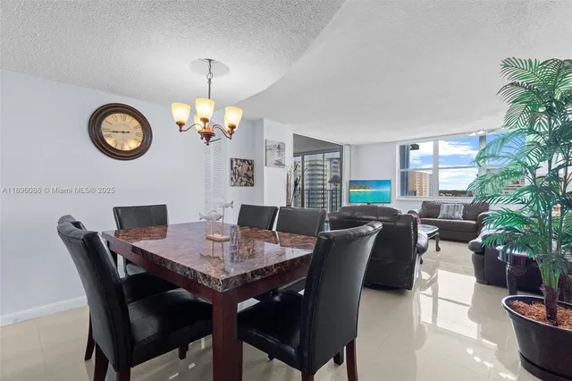 a view of a dining room with furniture and a potted plant