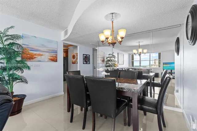 a view of a dining room with furniture wooden floor and chandelier