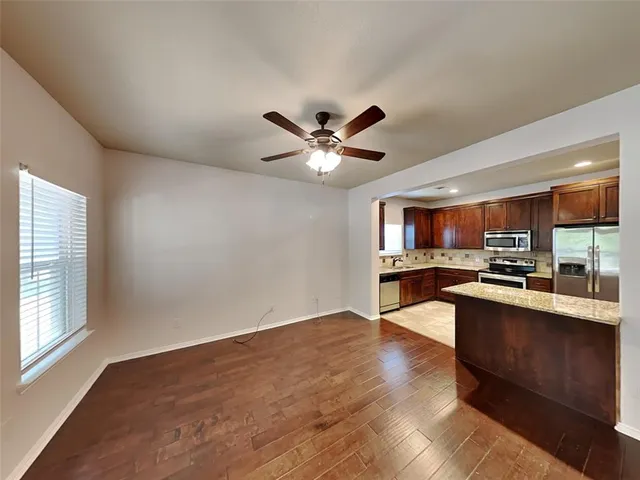 a view of kitchen with sink microwave and stove