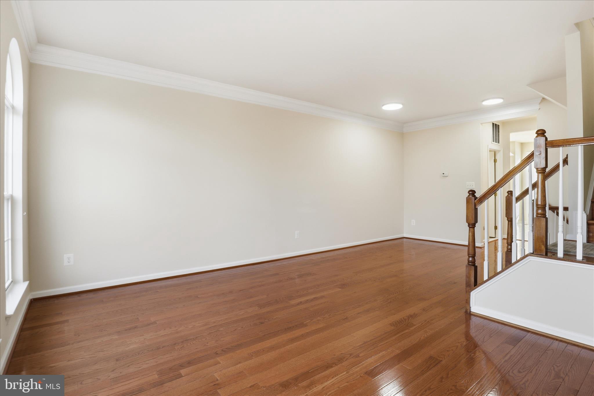 20432 Homeland Terrace Ashburn, VA 20147 - Photo 11 of 43 a view of an empty room with wooden floor and a window