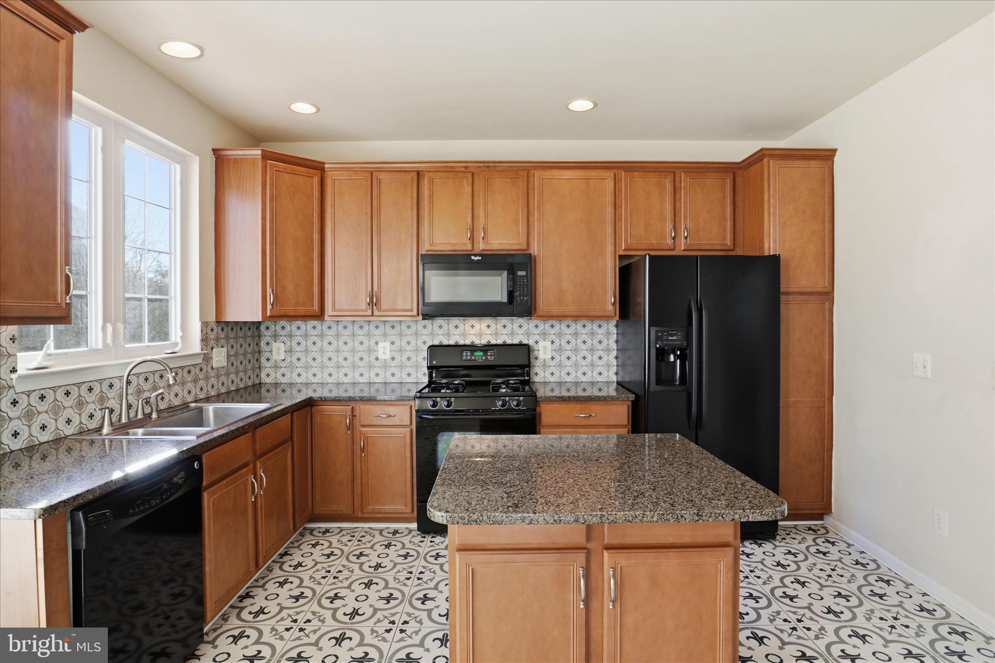 20432 Homeland Terrace Ashburn, VA 20147 - Photo 14 of 43 a kitchen with stainless steel appliances granite countertop a refrigerator sink and stove