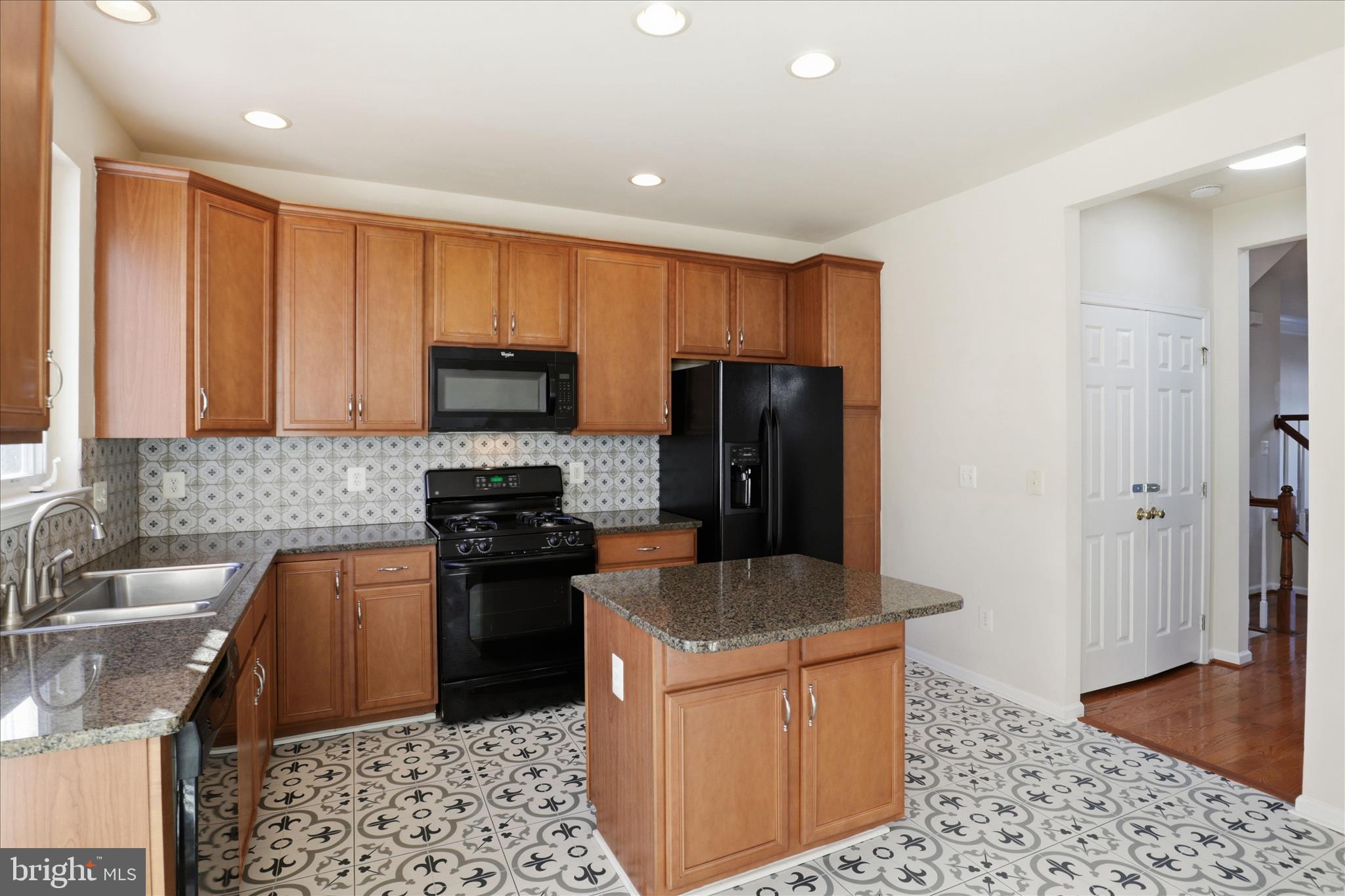 20432 Homeland Terrace Ashburn, VA 20147 - Photo 15 of 43 a kitchen with stainless steel appliances granite countertop a refrigerator a stove top oven a sink and dishwasher