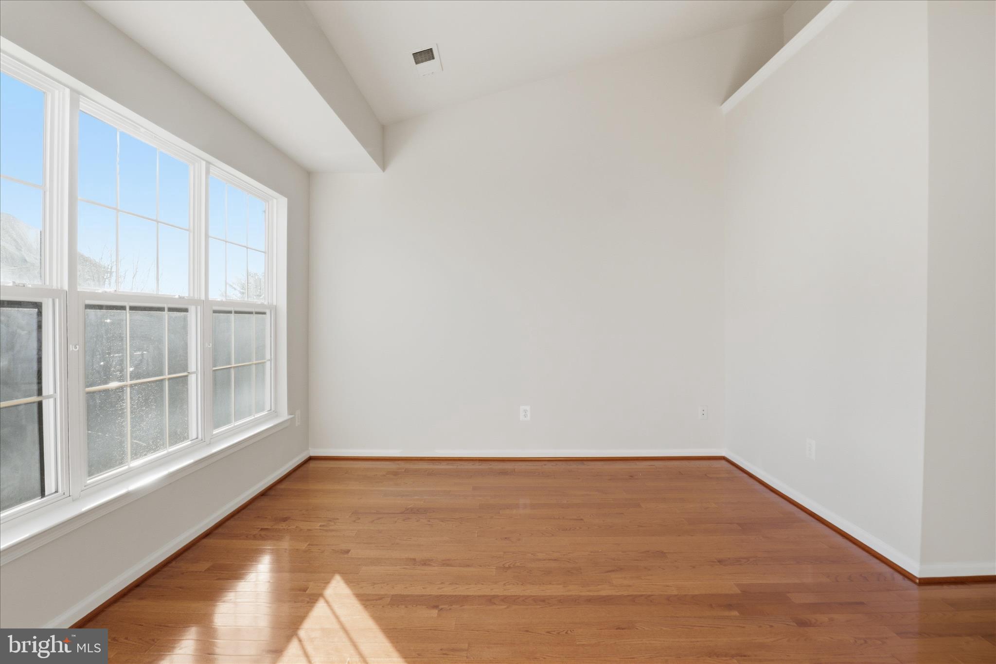 20432 Homeland Terrace Ashburn, VA 20147 - Photo 21 of 43 a view of an empty room with wooden floor and a window