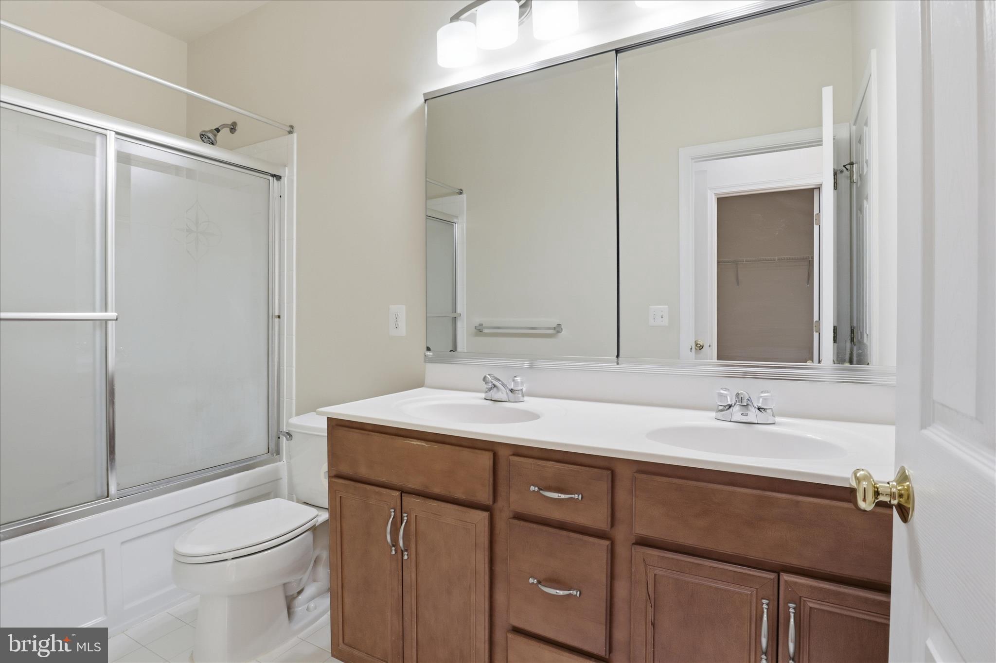 20432 Homeland Terrace Ashburn, VA 20147 - Photo 28 of 43 a bathroom with a sink a toilet and shower