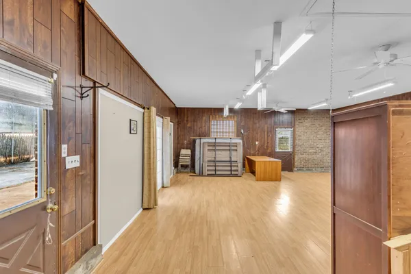 a view of a kitchen with furniture and a refrigerator