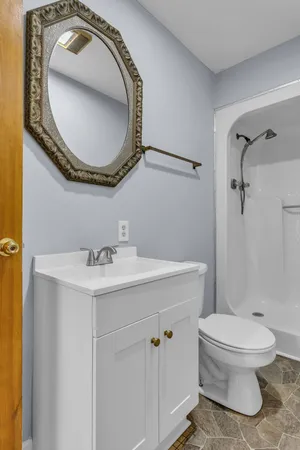 a bathroom with a glass shower door