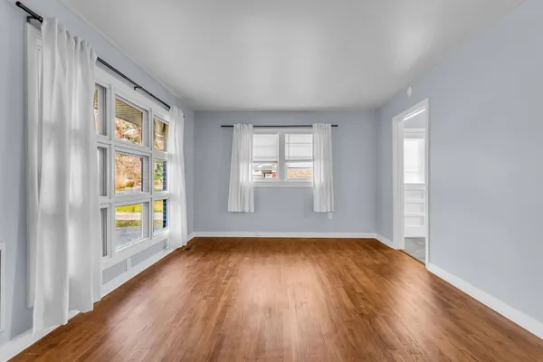 a view of an empty room with glass door and balcony