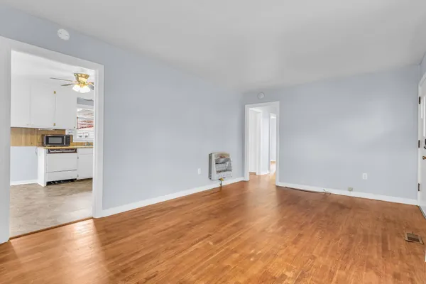 a kitchen with granite countertop a stove top oven and cabinets