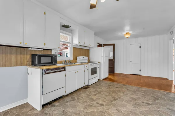 a view of a kitchen with electric appliances