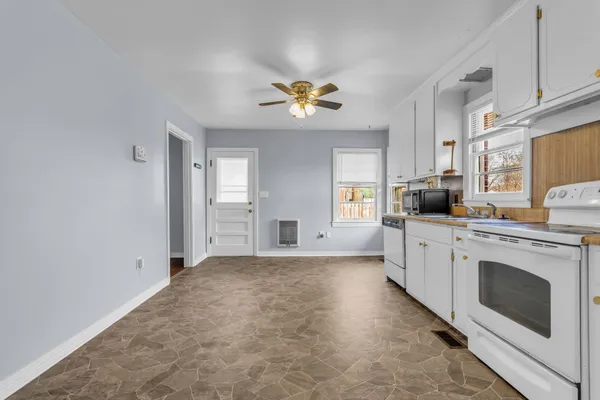 a kitchen with stainless steel appliances a refrigerator sink and cabinets
