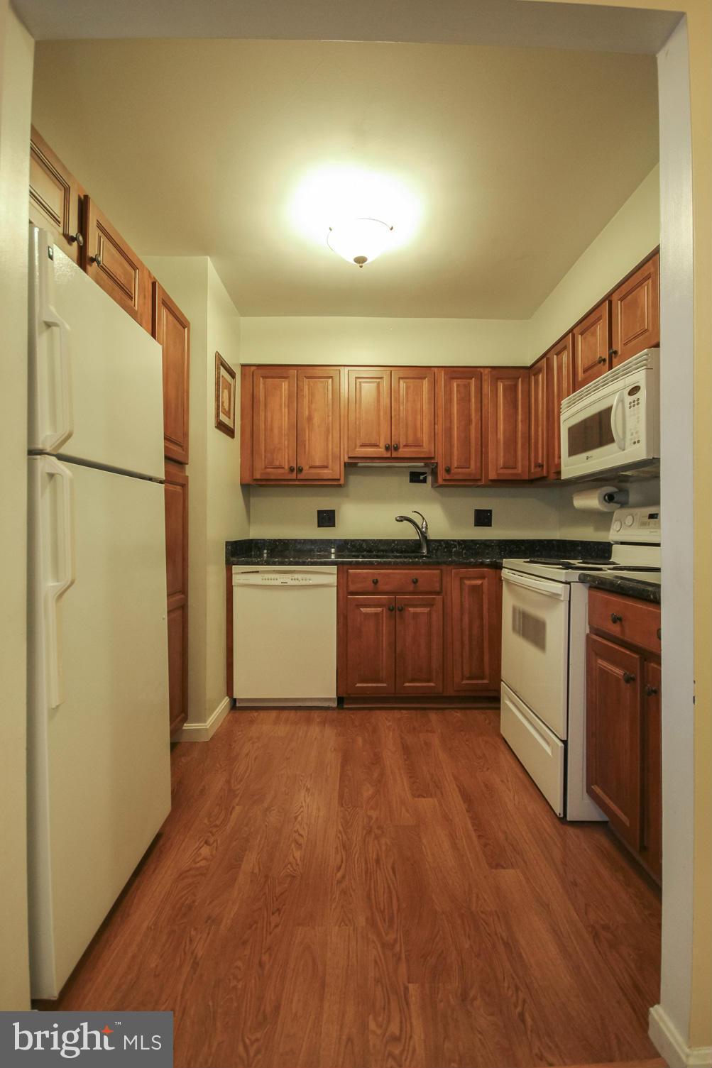 6155 Edsall Road, Unit 6155 Alexandria, VA 22304 - Photo 2 of 29 a kitchen with a white cabinets and white appliances