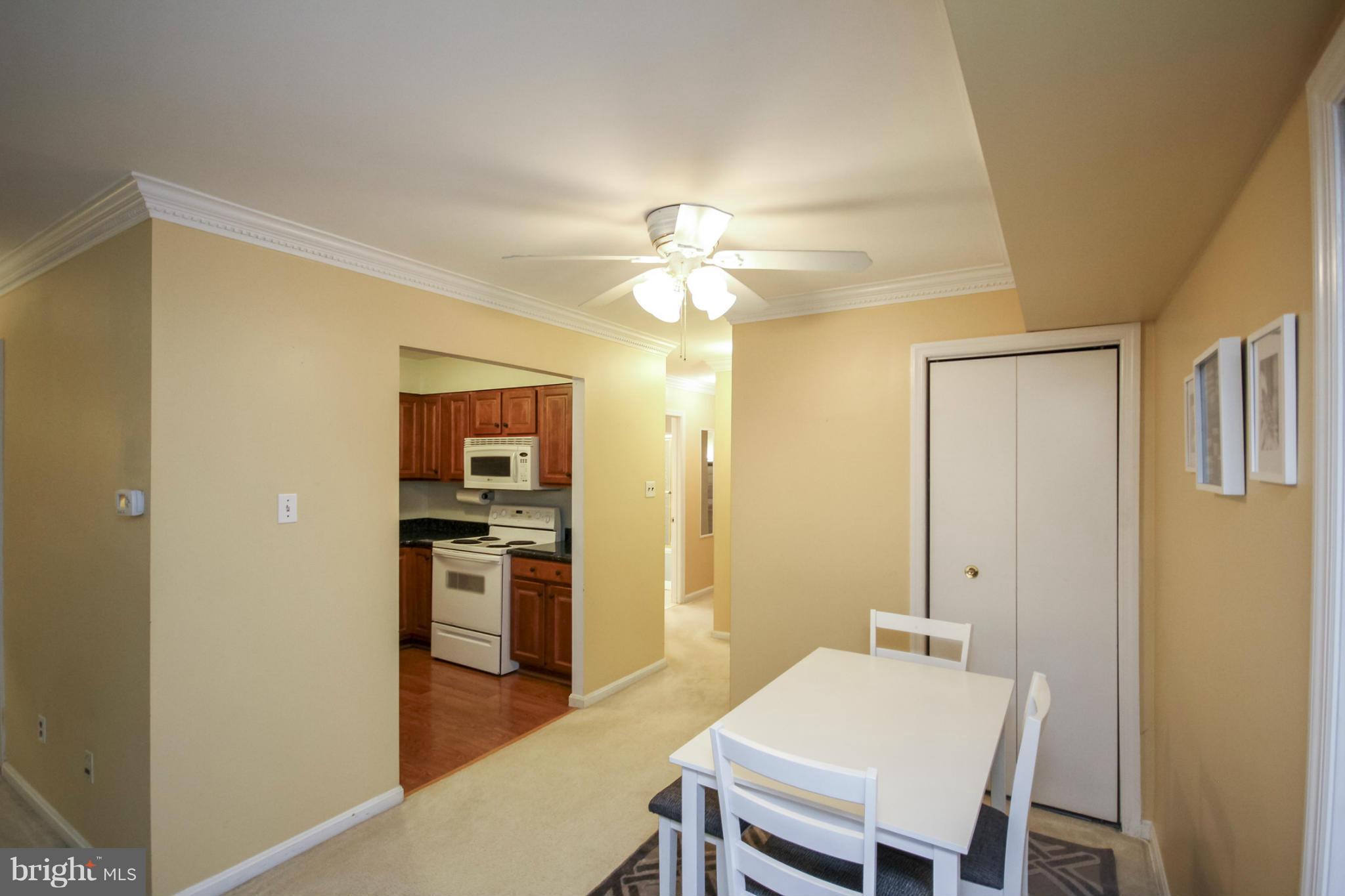 6155 Edsall Road, Unit 6155 Alexandria, VA 22304 - Photo 11 of 29 a view of a dining room with furniture and a chandelier