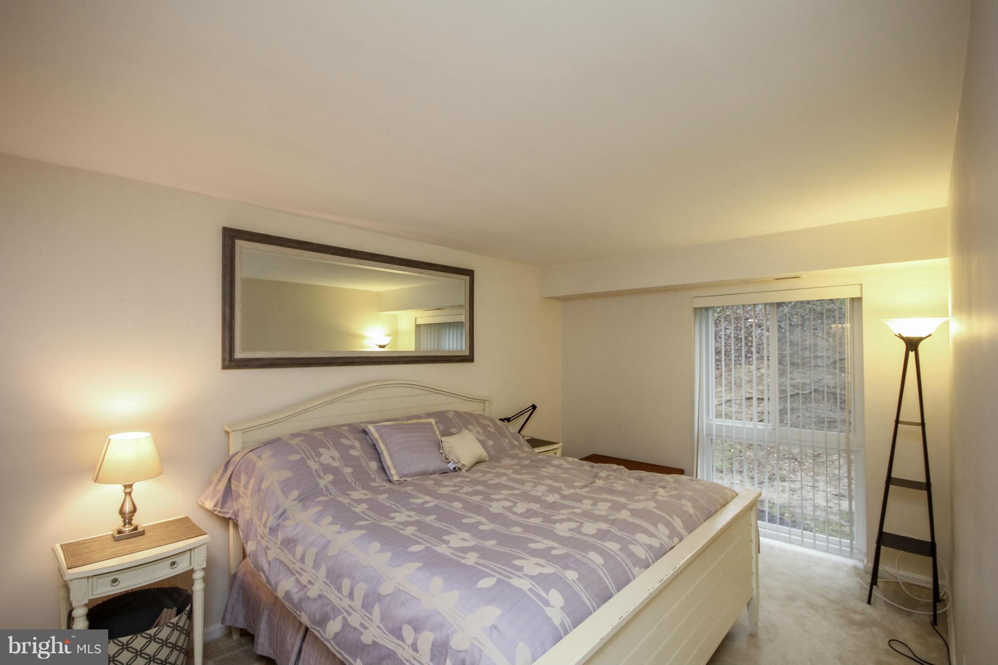 6155 Edsall Road, Unit 6155 Alexandria, VA 22304 - Photo 13 of 29 a bedroom with a bed and a lamp with the dresser