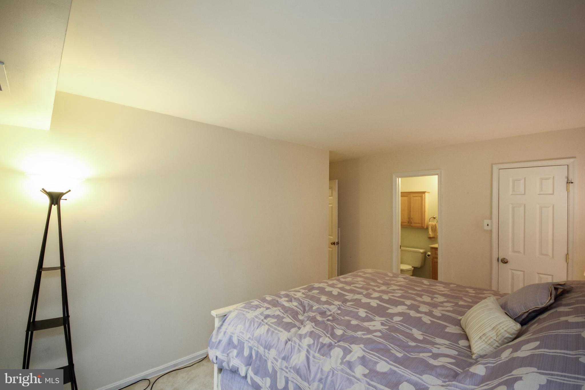 6155 Edsall Road, Unit 6155 Alexandria, VA 22304 - Photo 14 of 29 a bedroom with a bed and a mirror