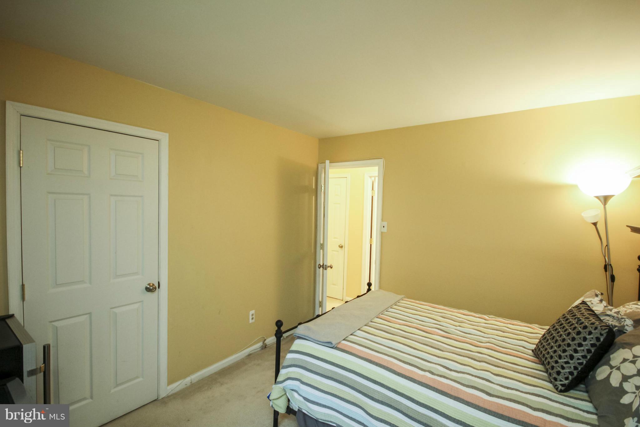 6155 Edsall Road, Unit 6155 Alexandria, VA 22304 - Photo 19 of 29 a bedroom with a bed and a mirror