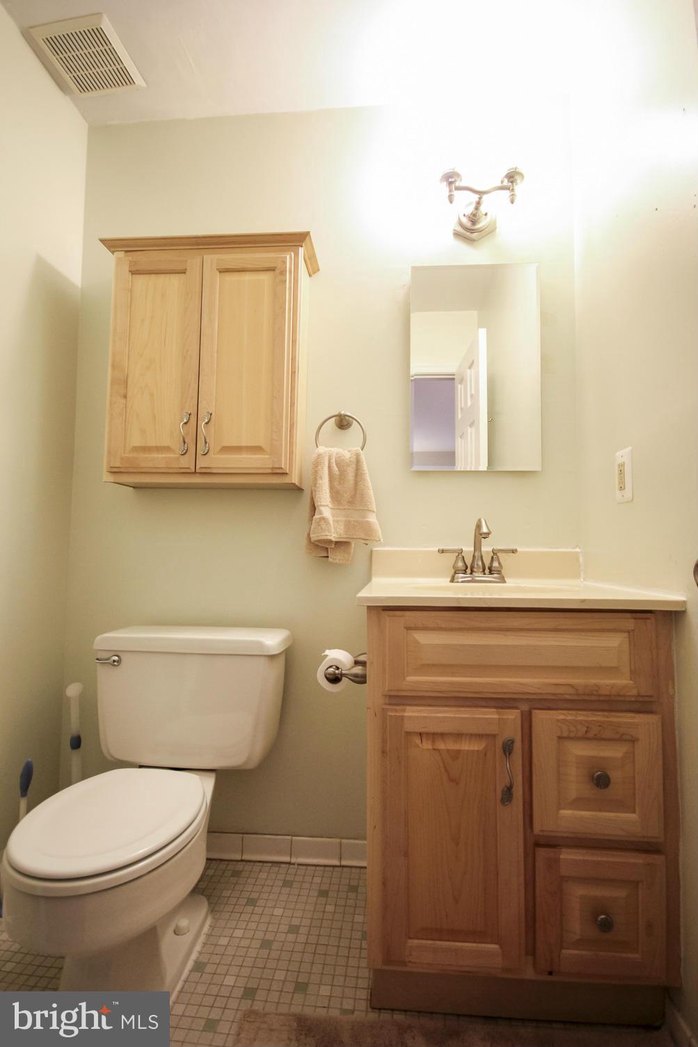 6155 Edsall Road, Unit 6155 Alexandria, VA 22304 - Photo 21 of 29 a bathroom with a granite countertop toilet sink and mirror