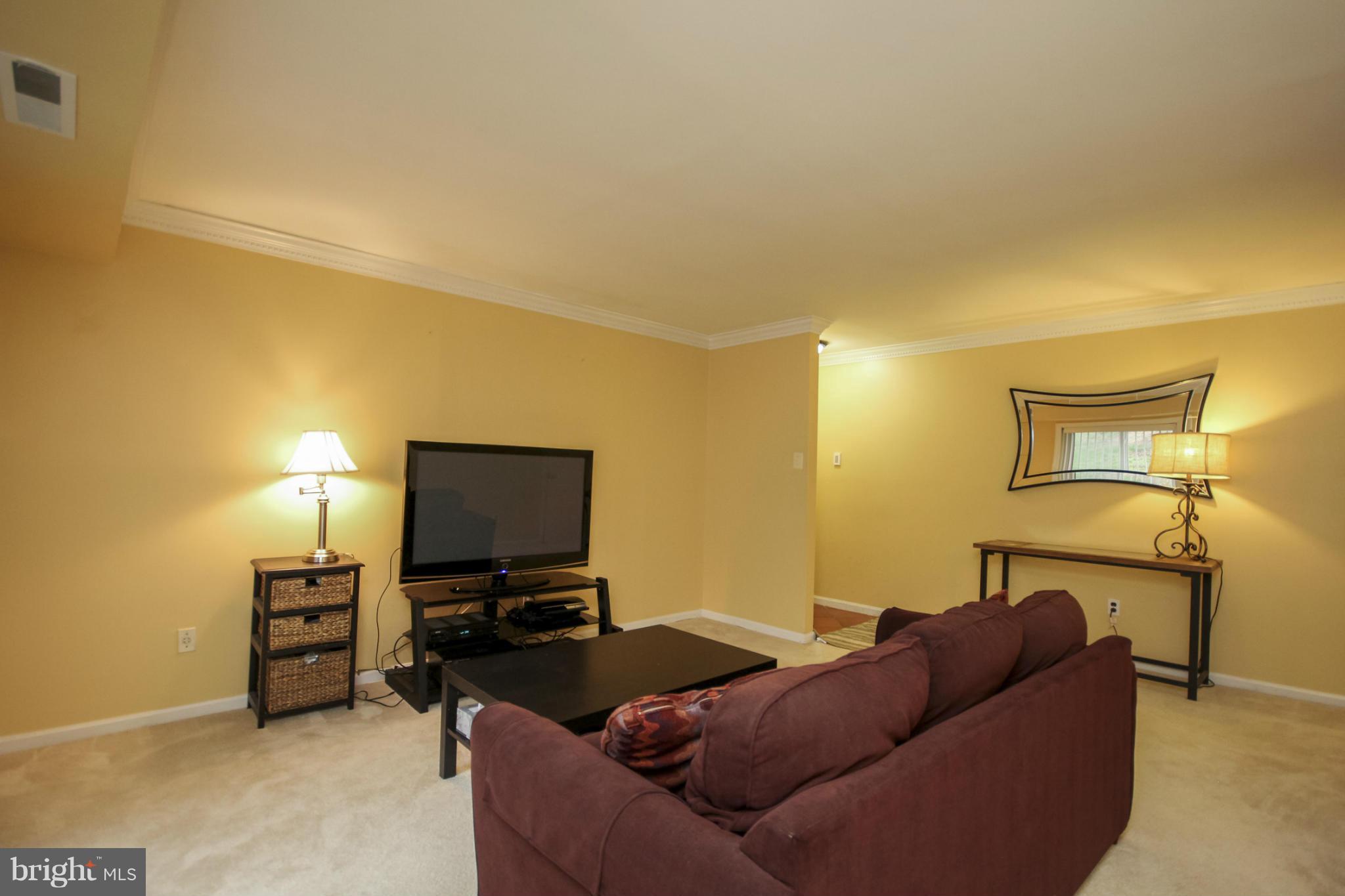 6155 Edsall Road, Unit 6155 Alexandria, VA 22304 - Photo 22 of 29 a living room with furniture and a flat screen tv