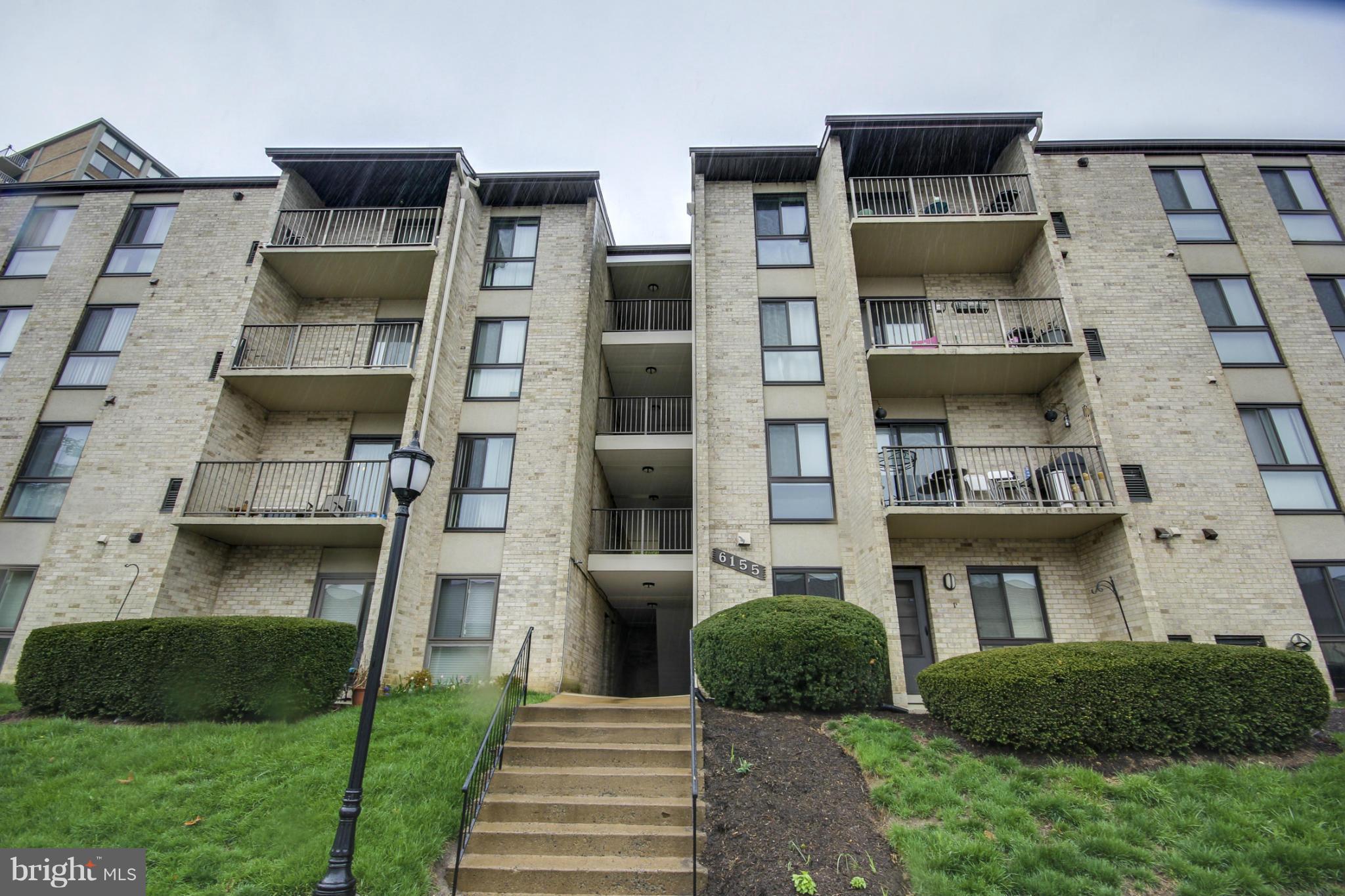 6155 Edsall Road, Unit 6155 Alexandria, VA 22304 - Photo 28 of 29 a front view of a residential apartment building with a yard