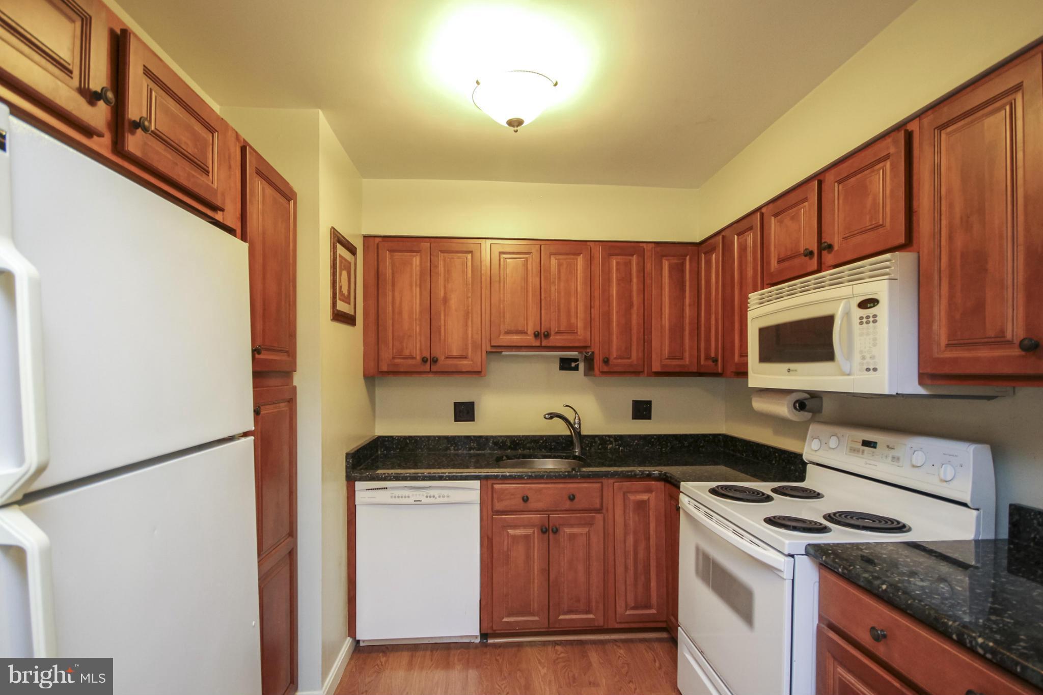 6155 Edsall Road, Unit 6155 Alexandria, VA 22304 - Photo 6 of 29 a kitchen with stainless steel appliances granite countertop a stove a sink dishwasher and a refrigerator